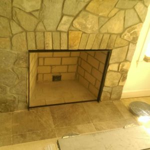 Yellow outdoor stone fireplace with bright flames in Washington, DC